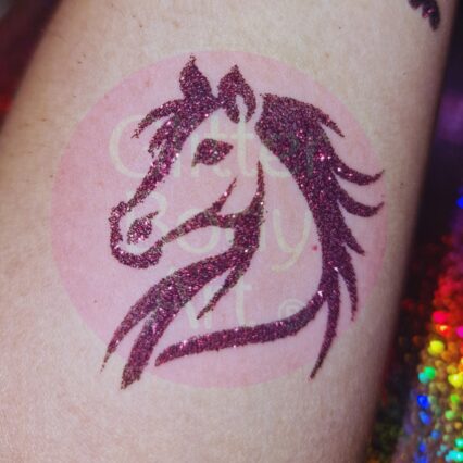 horses head stencil covered in glitter to make a glitter tattoo